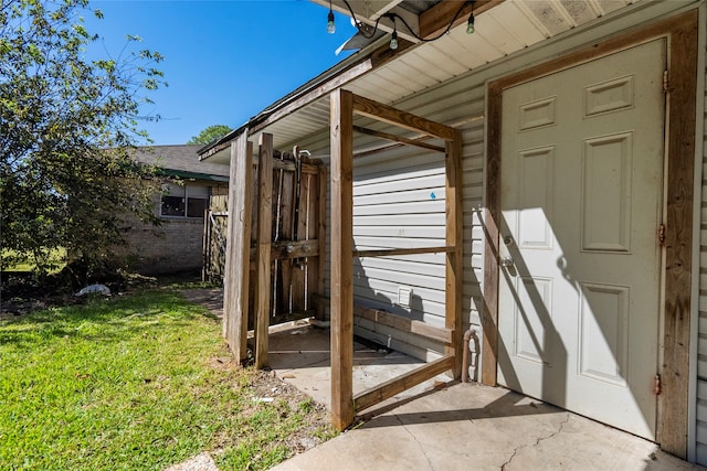 view of exterior entry with a lawn