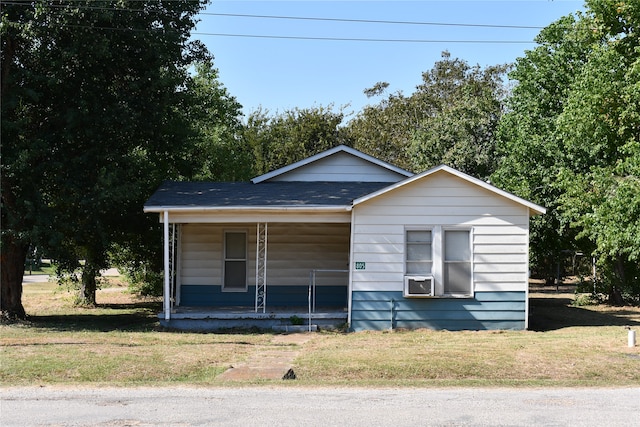 bungalow-style home with covered porch and a front yard