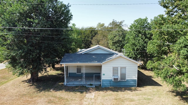 bungalow-style home with a front yard