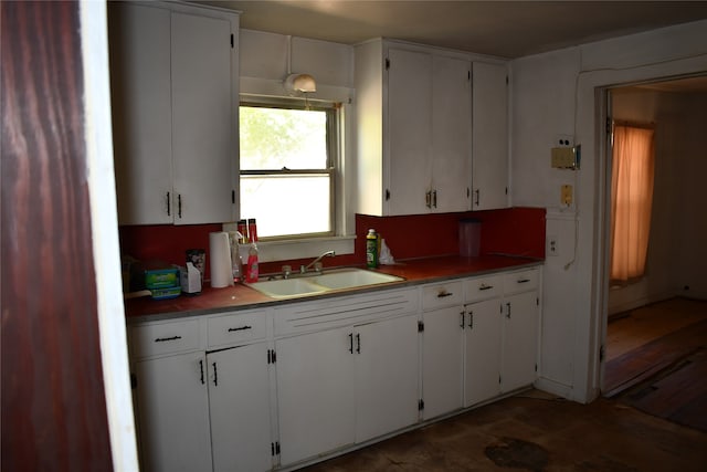 kitchen featuring sink, white cabinets, and dark wood-type flooring