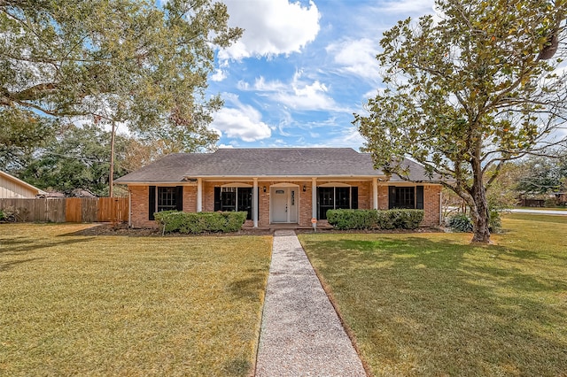 single story home featuring covered porch and a front lawn