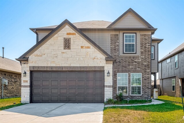 view of front of house with a front yard and a garage