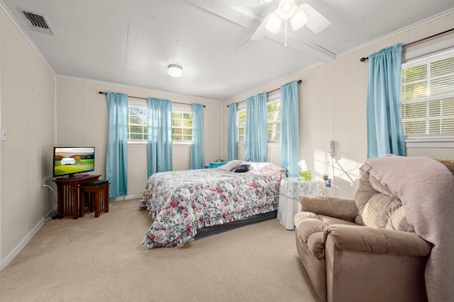 bedroom featuring ornamental molding, light colored carpet, and ceiling fan