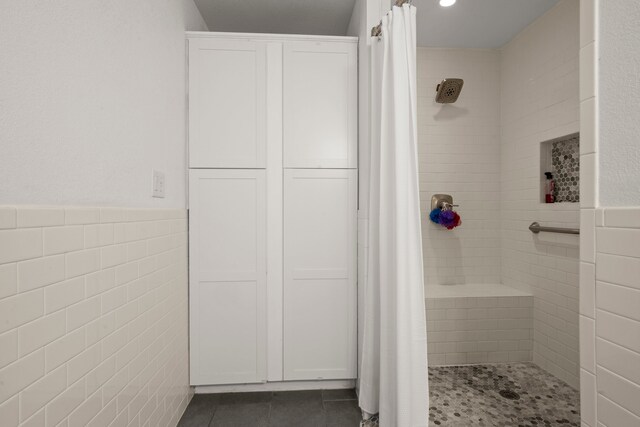 bathroom featuring tile walls, tile patterned floors, and a shower with shower curtain