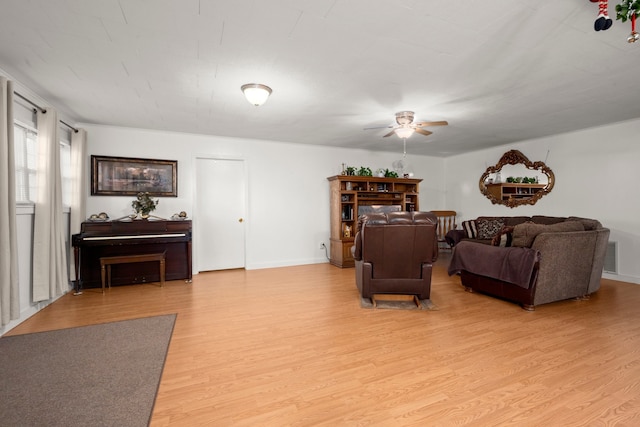 living room featuring light hardwood / wood-style floors and ceiling fan