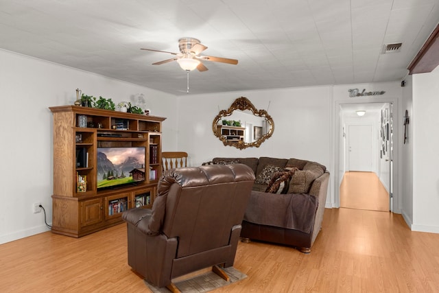 living room featuring ceiling fan and light wood-type flooring