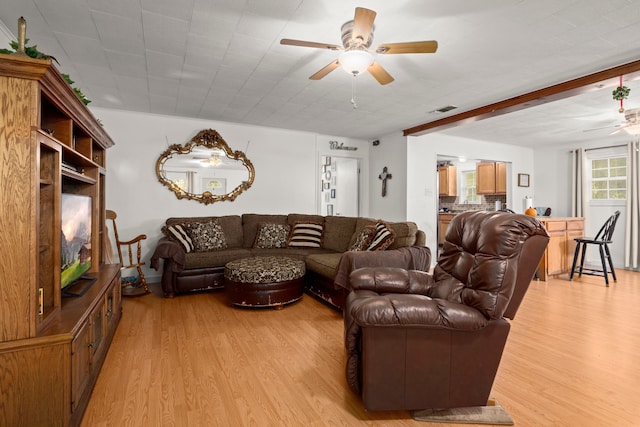 living room with light hardwood / wood-style floors and ceiling fan