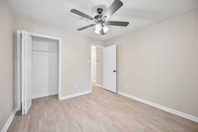 unfurnished bedroom featuring a closet, ceiling fan, and light wood-type flooring