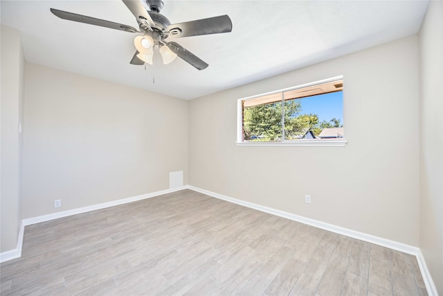 empty room with ceiling fan and light hardwood / wood-style flooring