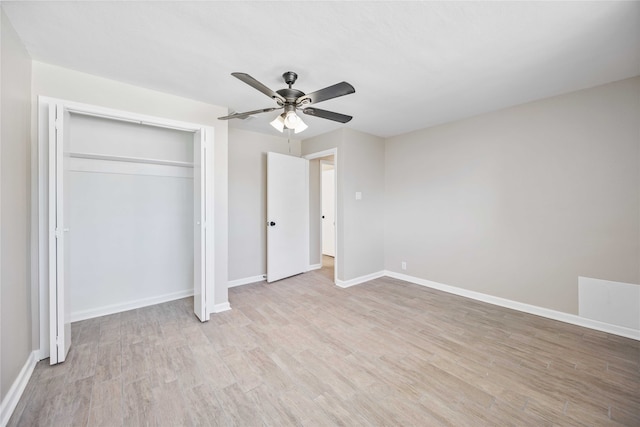 unfurnished bedroom featuring light hardwood / wood-style flooring, a closet, and ceiling fan