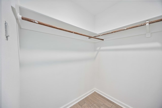 spacious closet featuring hardwood / wood-style flooring