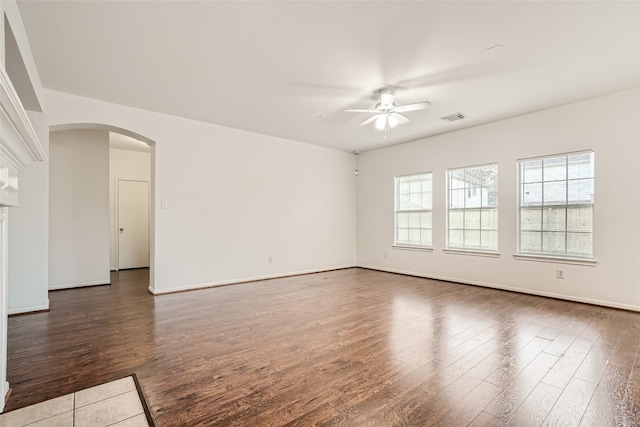 spare room with dark wood-type flooring and ceiling fan