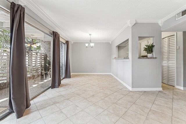 spare room with a notable chandelier, ornamental molding, and light tile patterned floors