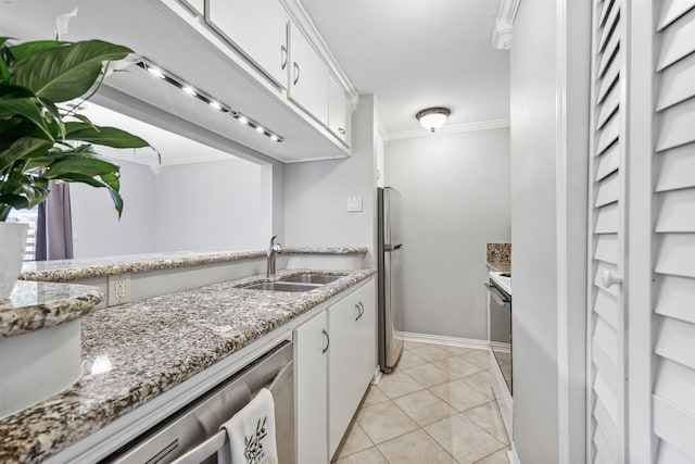 kitchen with sink, stainless steel appliances, white cabinets, crown molding, and light tile patterned floors