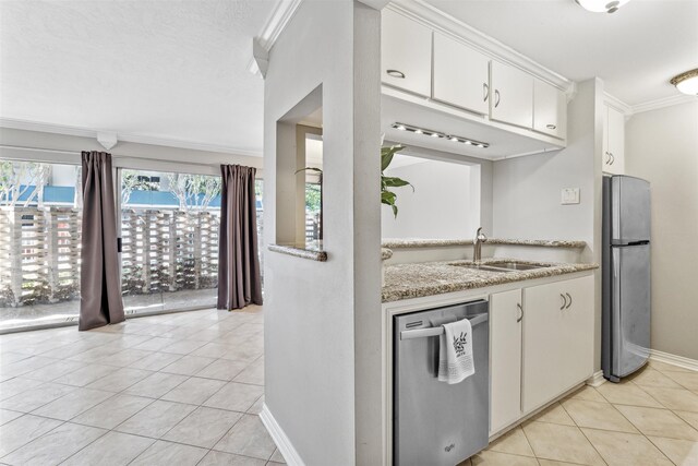 kitchen with stainless steel appliances, ornamental molding, sink, light tile patterned floors, and white cabinetry