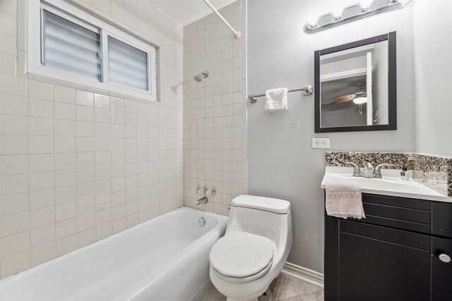 full bathroom featuring toilet, tiled shower / bath, and vanity