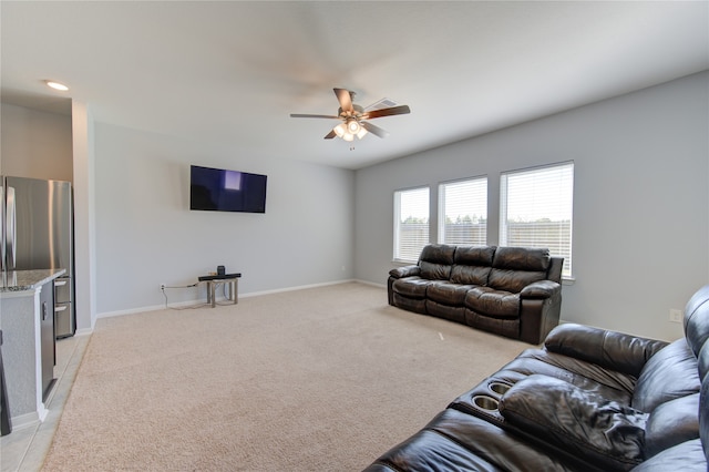 living room with ceiling fan and light colored carpet