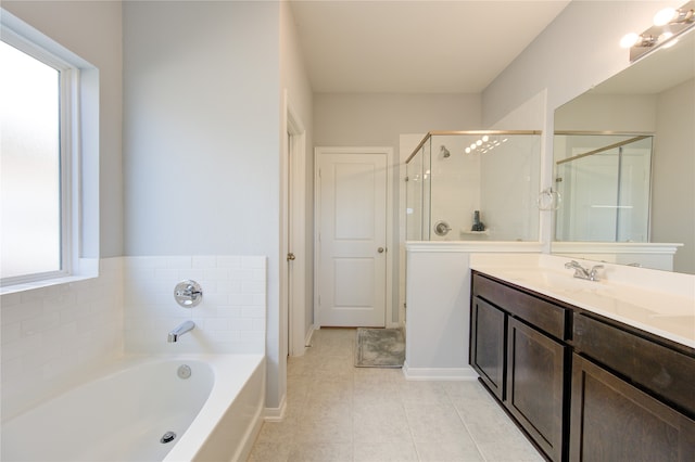 bathroom featuring vanity, independent shower and bath, and tile patterned floors