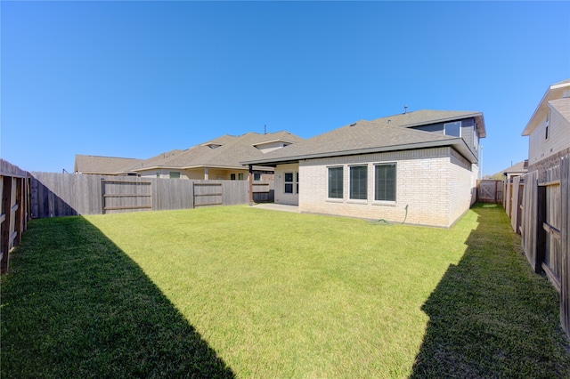 rear view of property with a lawn