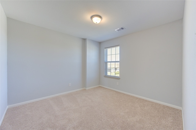 unfurnished room with light carpet