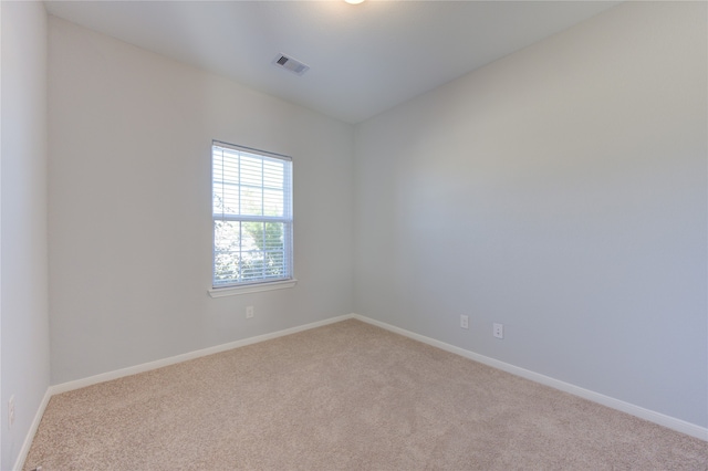 unfurnished room featuring light colored carpet