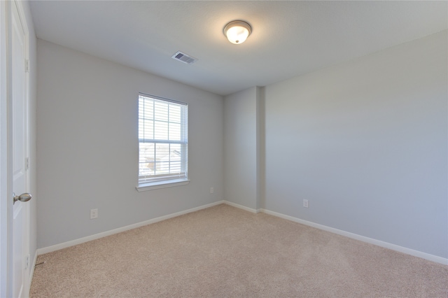 unfurnished room with light carpet