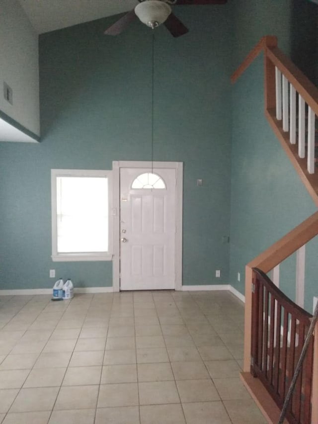 tiled entrance foyer featuring high vaulted ceiling and ceiling fan