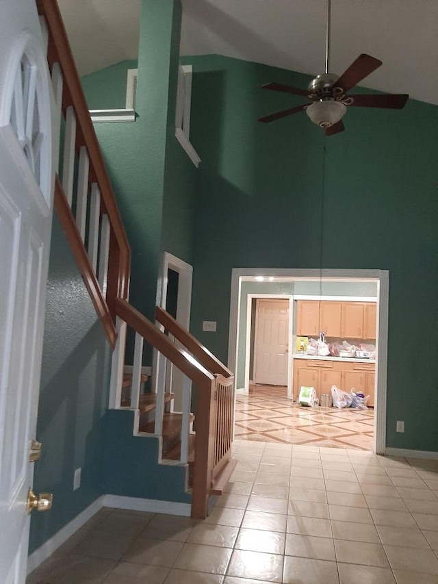 tiled entryway with high vaulted ceiling and ceiling fan