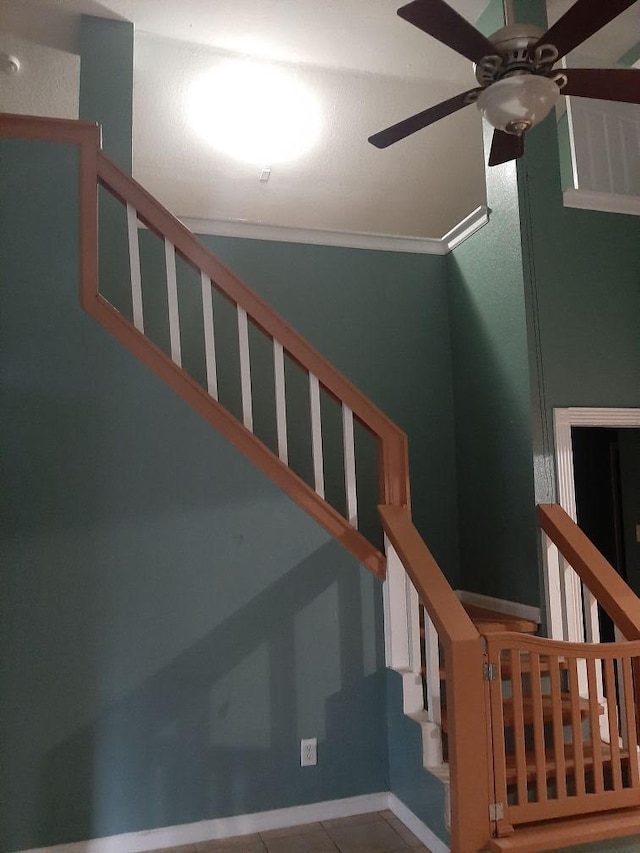 stairway with ornamental molding and ceiling fan