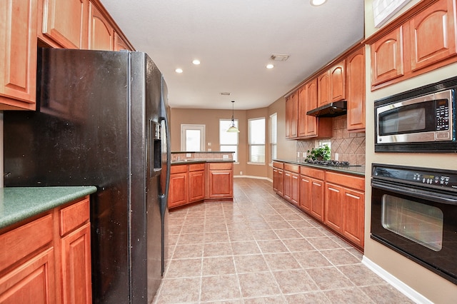 kitchen featuring black appliances, decorative backsplash, pendant lighting, and light tile patterned flooring