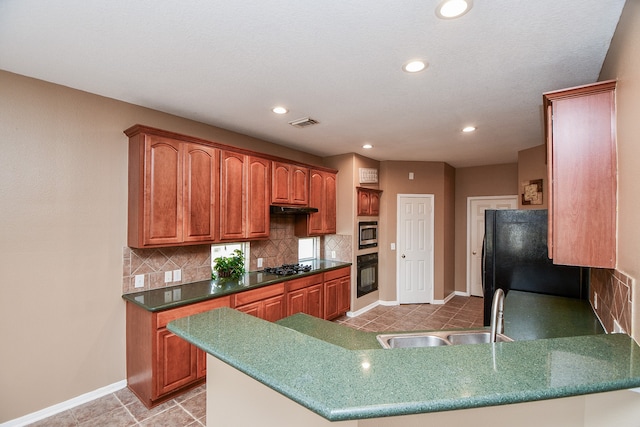 kitchen with sink, black appliances, decorative backsplash, and kitchen peninsula