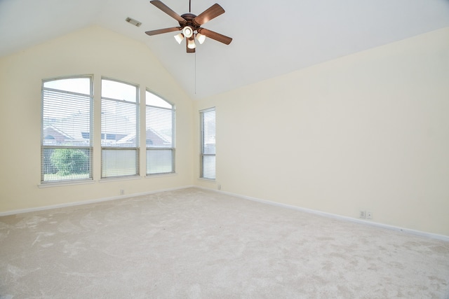 spare room featuring lofted ceiling, light colored carpet, and ceiling fan