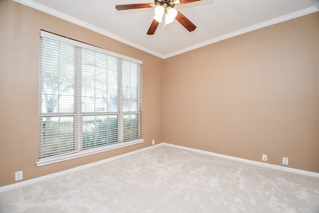 carpeted spare room featuring ornamental molding and ceiling fan