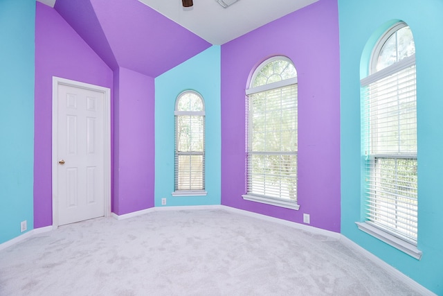 carpeted empty room with lofted ceiling and ceiling fan