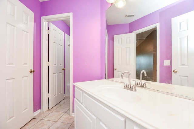 bathroom with vanity, a bathing tub, and tile patterned floors