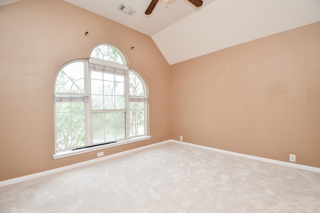 empty room with ceiling fan, carpet, and vaulted ceiling