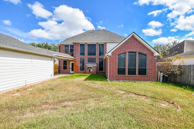 back of property featuring a yard