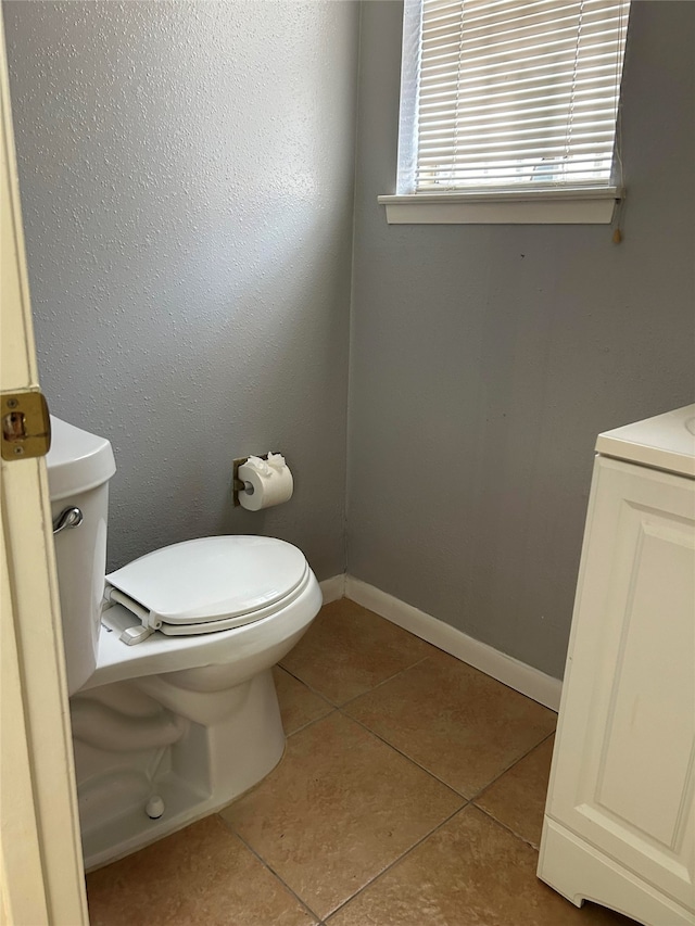 bathroom featuring vanity, toilet, and tile patterned flooring