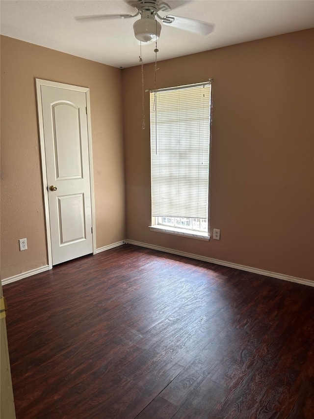 unfurnished room with ceiling fan, plenty of natural light, and dark hardwood / wood-style floors