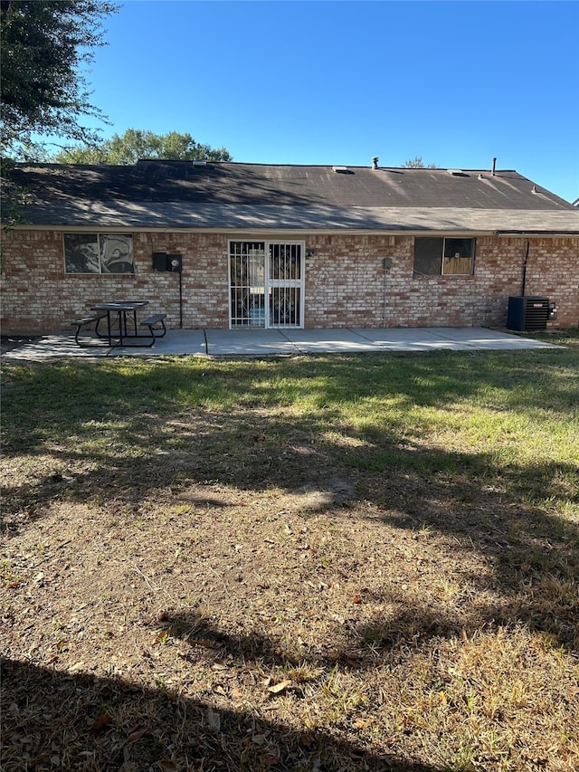 back of house featuring a patio, a yard, and central AC unit