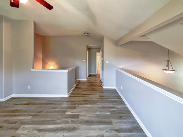 hall featuring wood-type flooring and vaulted ceiling