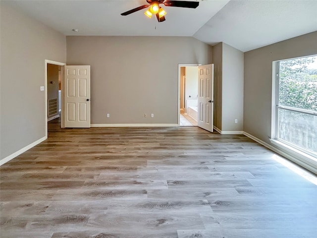 unfurnished bedroom featuring light hardwood / wood-style floors, lofted ceiling, and ceiling fan