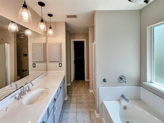 bathroom with vanity, a bath, and tile patterned flooring