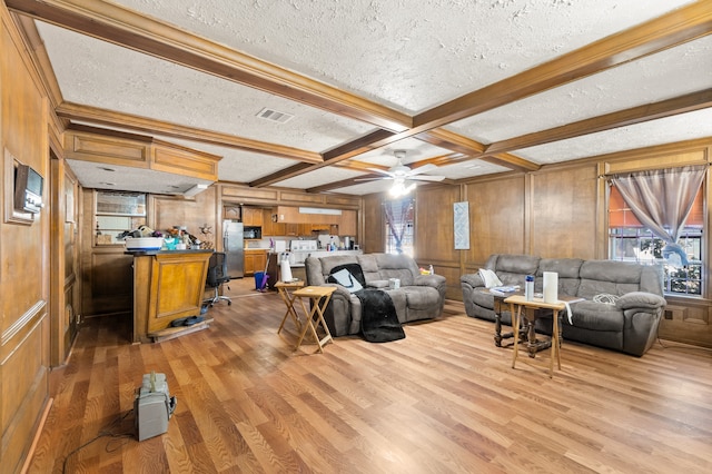 living room with a textured ceiling and wooden walls