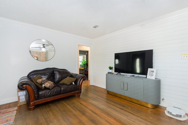 living room featuring dark hardwood / wood-style flooring and crown molding