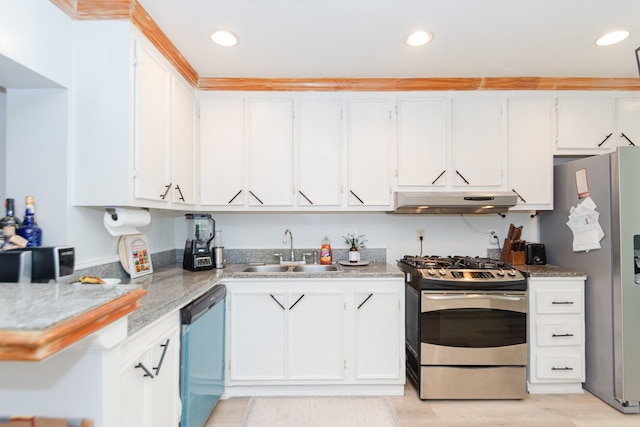 kitchen featuring appliances with stainless steel finishes, light hardwood / wood-style flooring, white cabinetry, and sink