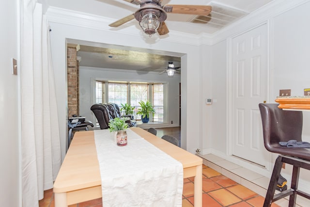 dining space with light tile patterned floors and crown molding