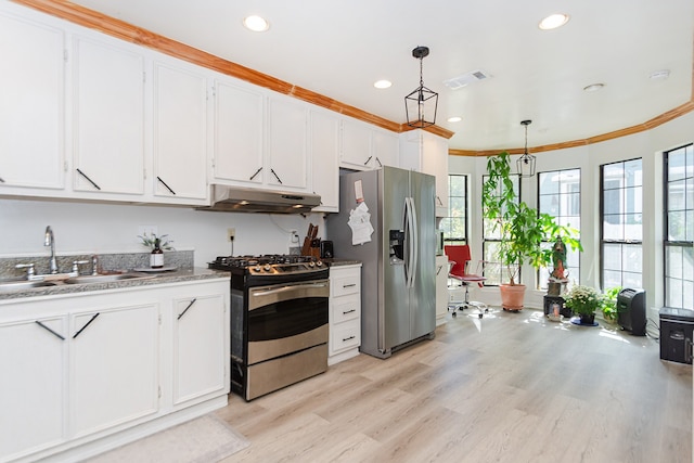 kitchen with white cabinetry, sink, pendant lighting, appliances with stainless steel finishes, and ornamental molding