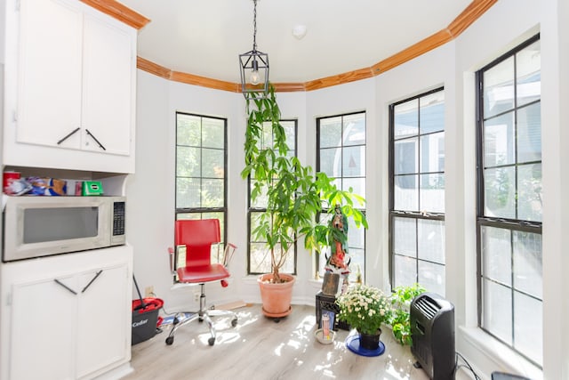 sunroom featuring heating unit and plenty of natural light