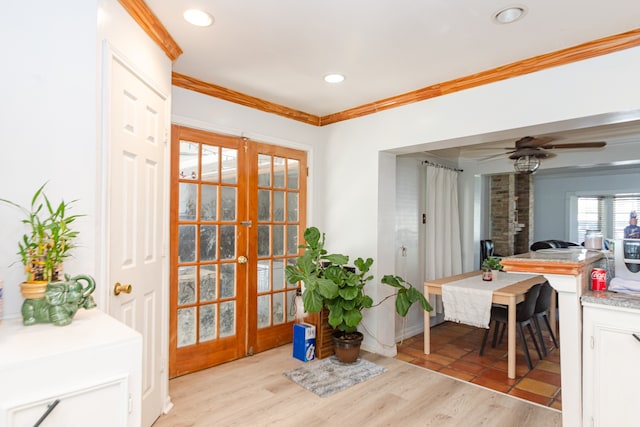 dining space featuring ceiling fan, light wood-type flooring, ornamental molding, and french doors